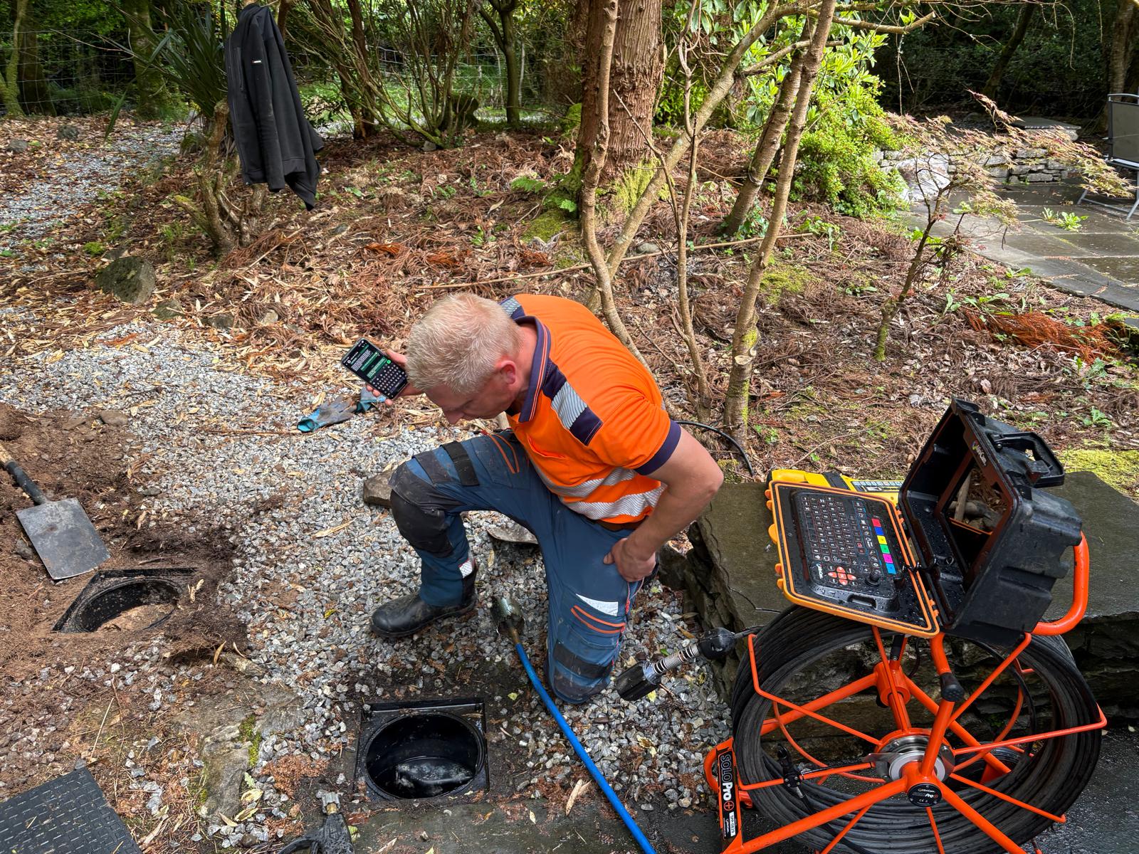 Drain technician in hi-vis gear